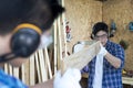 Carpenters working in teamwork. Two young man as carpenter work in the workshop