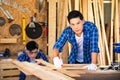 Carpenters are working in a wood factory. A carpenter or furniture maker made of wood