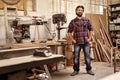 Carpentry business owner standing in his workshop with machinery Royalty Free Stock Photo