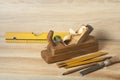 Carpentry concept.Joiner carpenter workplace. Old planer,level ,chisel and pencil on wooden table. Copy space for text. Royalty Free Stock Photo