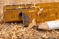 Carpentry measure in sawdust on a wooden table. Small carpentry work in a home workshop