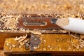 Carpentry measure, spirit level and pencil in sawdust on wooden table. Small carpentry work in a home workshop