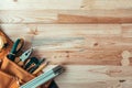 Carpentry tool belt on woodwork workshop desk, top view Royalty Free Stock Photo