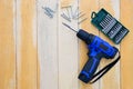 Carpentry tools of cordless drills,  screw driver, screws and accessories on wood table Royalty Free Stock Photo