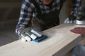Carpentry. Wood sanding. Orbital sander for woodworking Royalty Free Stock Photo