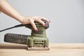 Carpentry work, hand of a woman with her nails done sanding wood, using a sander Royalty Free Stock Photo