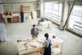 Carpentry workers making wooden frames in workshop Royalty Free Stock Photo