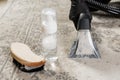 Carpet cleaning tools with foam brush and extractor nozzle on patterned rug Royalty Free Stock Photo