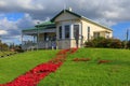 A carpet of red Anzac Day poppies outside a historic house, New Zealand