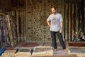 Carpet seller welcomes buyers in his small shop during Desert Safari tour Royalty Free Stock Photo