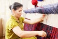 Carpet weaver sideview closeup