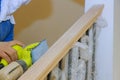 Carpeted in refinishing the stairwell of railing in a Sandpaper sanding