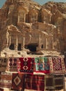 Carpets with the national ornament against the background of the beautiful facade of the palace of the tomb in the ancient