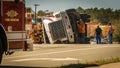 Carrboro NC, /US-March 10 2017:Men working on overturned logging truck