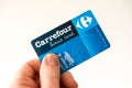 Carrefour supermarket bonus or loyalty card, hand holding card on white background Royalty Free Stock Photo