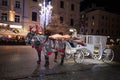 A carriage with horses. Christmas square. Krakow. Celebration. Night fair. Feast of approaching Royalty Free Stock Photo