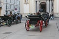 Carriage with horses, driver and tourists in Vienna on a sightseeing tour around the city