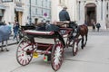 Carriage with horses, driver and tourists in Vienna on a sightseeing tour around the city