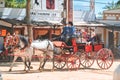 Carriage pulled by group of horses with decorations and people dressed in traditional clothes at Jerez fair Royalty Free Stock Photo