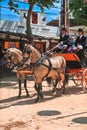 Carriage pulled by group of horses with decorations and people dressed in traditional clothes at Jerez fair Royalty Free Stock Photo