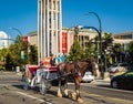 Carriage Ride In Victoria BC Canada. A horse drawn carriage with tourists passes the historical buildings in Victoria