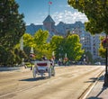 Carriage Ride In Victoria BC Canada at sunset. A horse drawn carriage with tourists passes the historical buildings