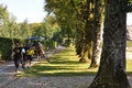 Carriage with tourists in a Herreninsel island King Ludwig II Palace garden. Horse Carriage Trip. Royalty Free Stock Photo