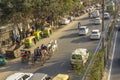 Carriage with two white horses in city traffic on Indian streets aerial view