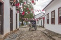 A carriage in a street adorned with flags for the Divine Holy Spirit Festivity in Paraty, Brazil. Royalty Free Stock Photo