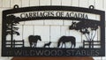 The Carriages of America at Wildwood Stables black wrought metal sign