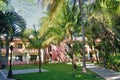 Carribean resort hotel partly hidden by trees