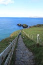 Way to Carrick-a-Rede Rope Bridge - Island in blue ocean with light blue sky - Northern Ireland tourism