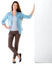 She carries herself with confidence. Studio portrait of a confident young woman leaning against a wall.