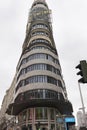 Carrion building front facade with cloudy grey sky at background