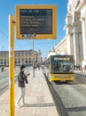 Carris bus 781 in Lisbon approaching the stop with information panel on waiting times. Royalty Free Stock Photo