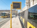 Carris bus in Lisbon approaching the stop with information panel on waiting times. Royalty Free Stock Photo