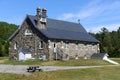 The rear of St. Patrick Mission Church in Twin Mountain NH, with a facade made of river rock Royalty Free Stock Photo