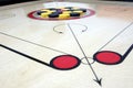 Carrom board with striker and coins