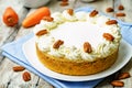 Carrot cake cheesecake with pecan on a wood background Royalty Free Stock Photo