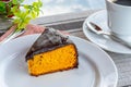 Carrot cake with chocolate icing, accompanied by a cup of coffee Royalty Free Stock Photo