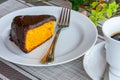 Carrot cake with chocolate icing, accompanied by a cup of coffee Royalty Free Stock Photo