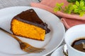 Carrot cake with chocolate icing, accompanied by a cup of coffee Royalty Free Stock Photo