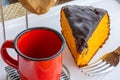 Carrot cake with chocolate icing, accompanied by a cup of coffee Royalty Free Stock Photo