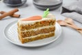 Carrot cake for mother`s Day.  Layer cake with grated carrots, walnuts and dried apricots, topped with cream cheese and frosting. Royalty Free Stock Photo