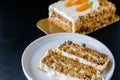 Carrot cake slices on white plate and dark background Royalty Free Stock Photo