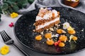 Carrot cake with walnuts on black plate Royalty Free Stock Photo