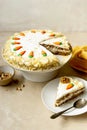 Carrot cake with walnuts an whipped cream, homemade easter cake baking, top view. Whole round cake Royalty Free Stock Photo