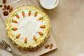 Carrot cake with walnuts an whipped cream, homemade easter cake baking, top view. Whole round cake Royalty Free Stock Photo