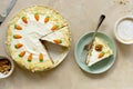 Carrot cake with walnuts an whipped cream, homemade easter cake baking, top view. Whole round cake Royalty Free Stock Photo