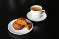 Carrot cakes with walnuts and spices, next to a white porcelain Cup of green tea Royalty Free Stock Photo